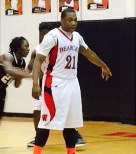 Weaver post Elliott Moore directs traffic during Monday's game. On the cover, Moore and Paul Hubbard (5) led the Bearcats to a 73-60 victory over Lincoln.