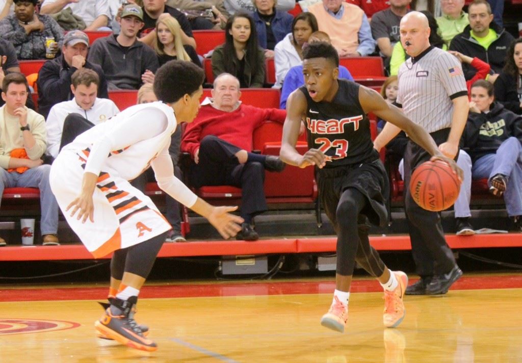 Sacred Heart's Kevion Nolan (23) gets ready to drive on Alexandria's Nick Porter. On the cover, the Cardinals race toward the student section to share their county tournament title celebration. (Inside photo by Chad Barnett)