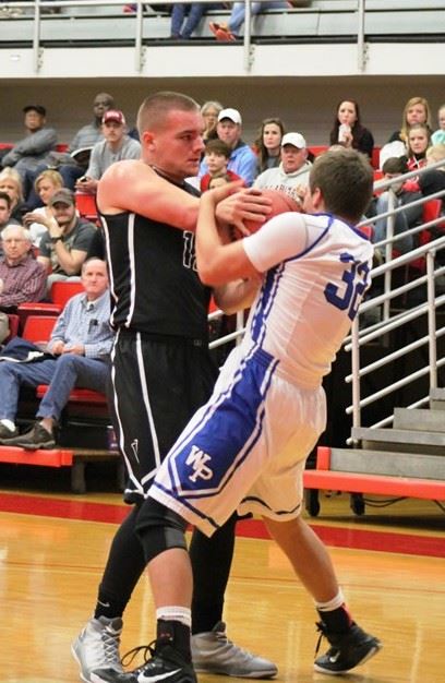 Wellborn's Landon Machristie and White Plains' Murphy Doss (32) fight for control of the ball during their game Monday. (Photo by Bridget Merriman)