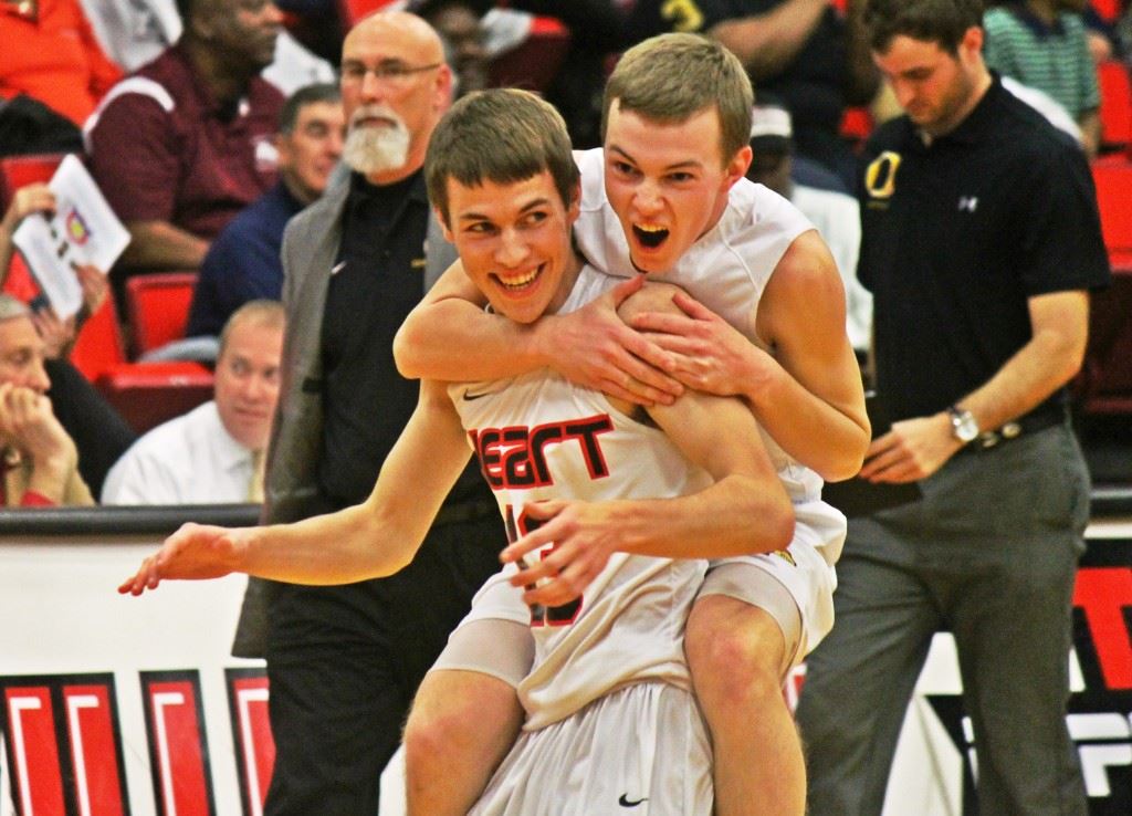 Caleb Lafollette jumps on the back of teammate Bradley Mayfield to celebrate Sacred Heart's tournament win over Oxford. (Photo by Chad Barnett)