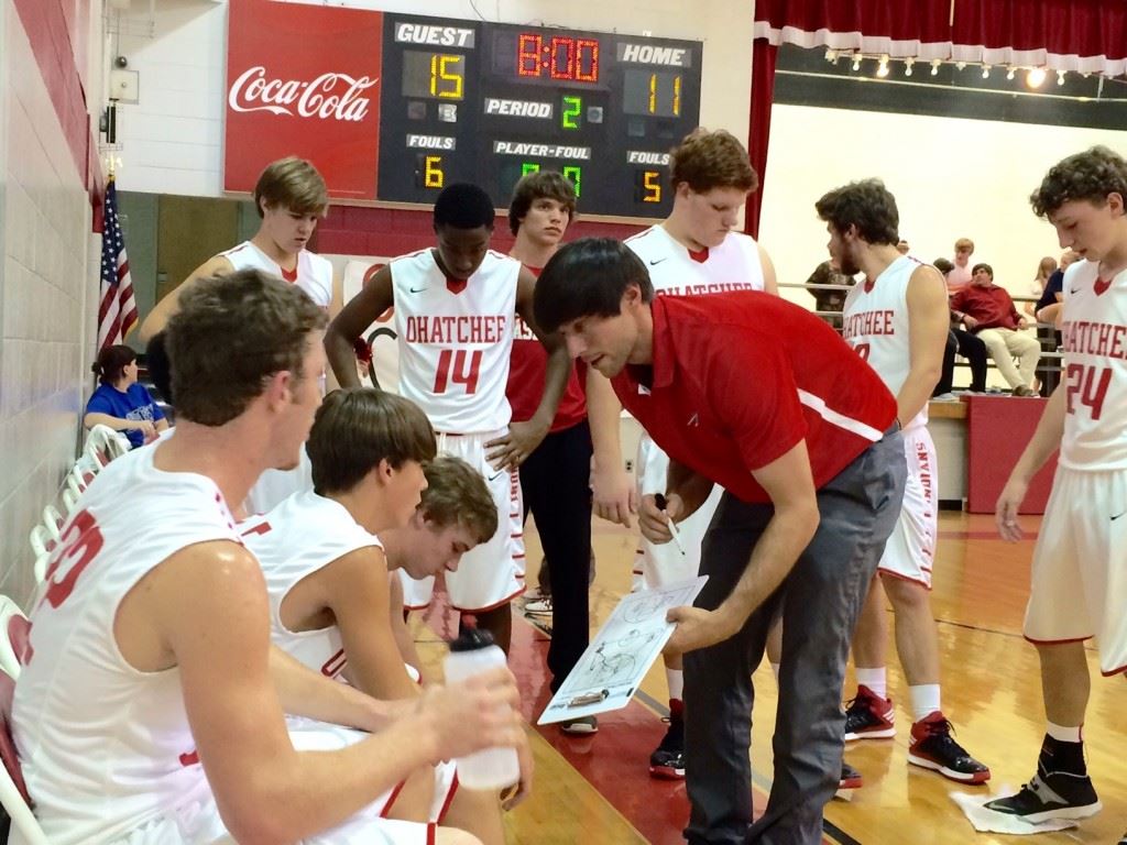 Freshman guard Ben Glass (second from left) listens intently to Ohatchee coach Bryant Ginn's instructions during a game earlier this season.