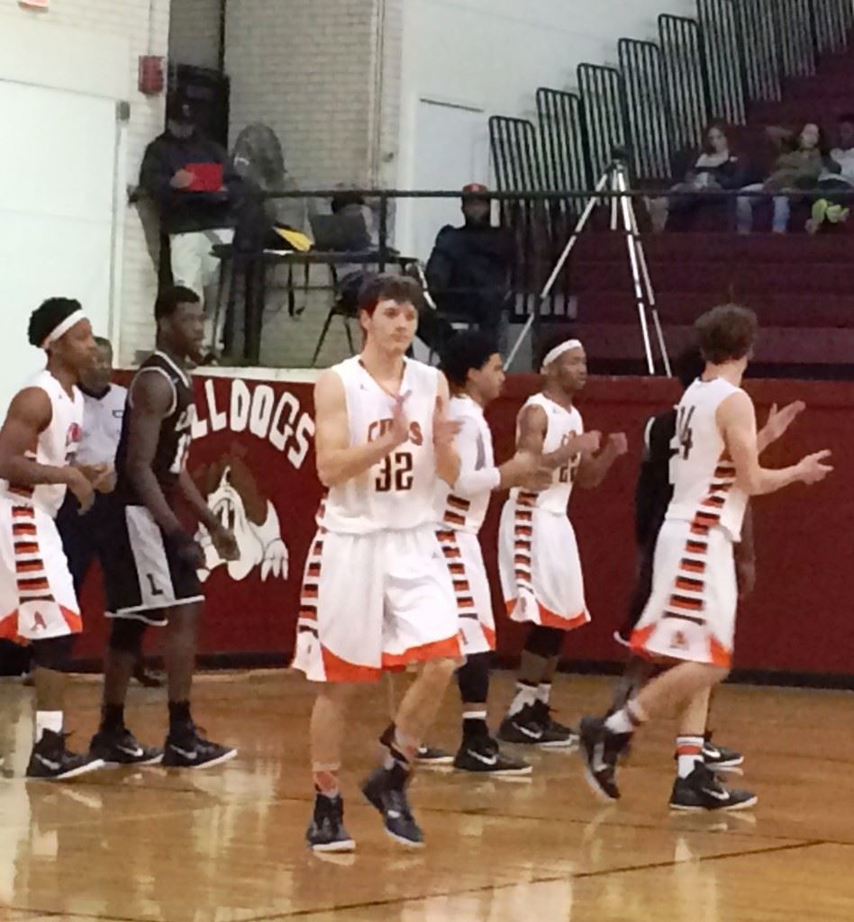 Dakota Kelley (center) leads his Alexandria teammates back down the floor after a turnover in their area tournament game with Lincoln.