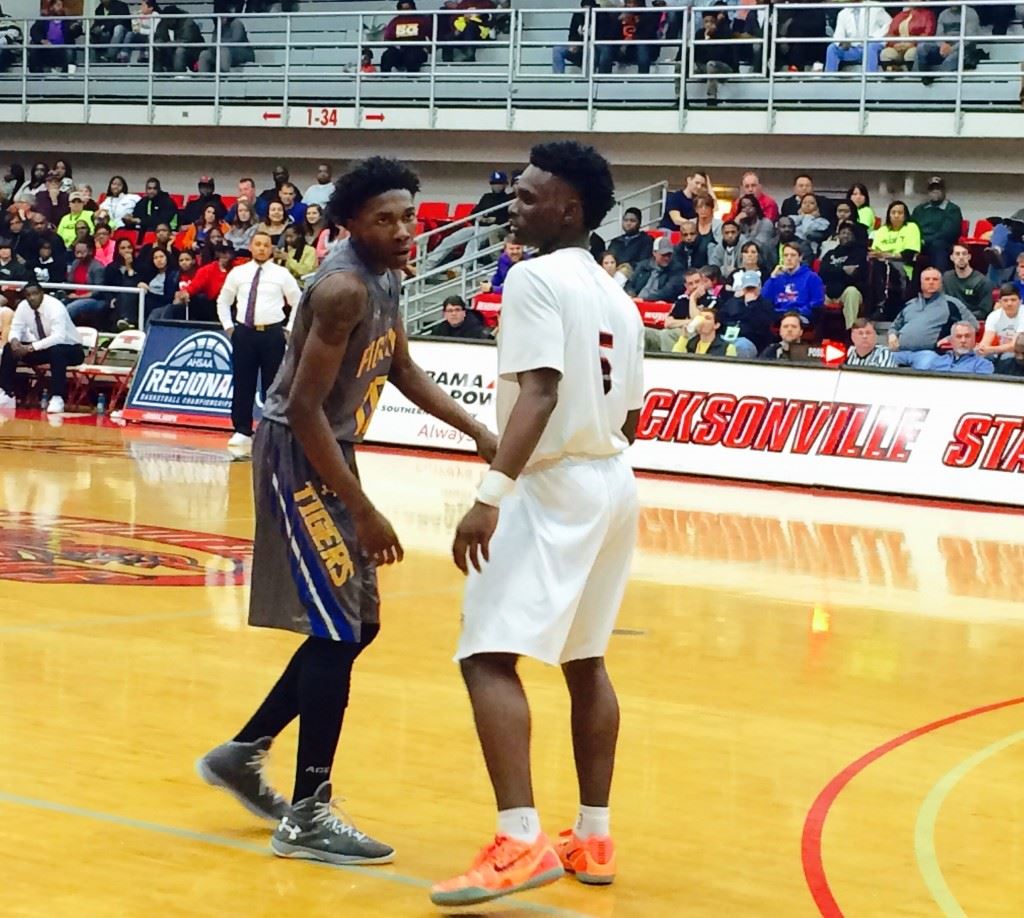 TCC's Crystyle Stockdale and Sacred Heart's D.J. Heath (5) face up during Tuesday's game. Stockdale scored 30 points and Heath was named tournament MVP.