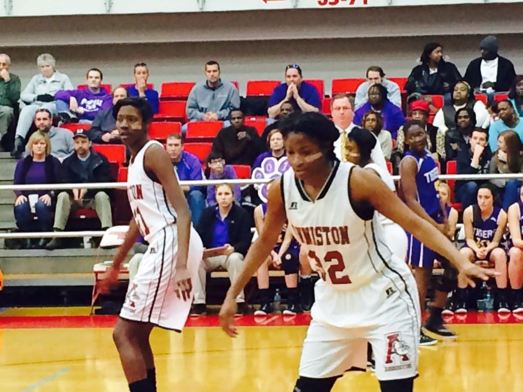 Anniston's Carsheuna Curry (32) and Takia Shears take their defensive stance against Springville.