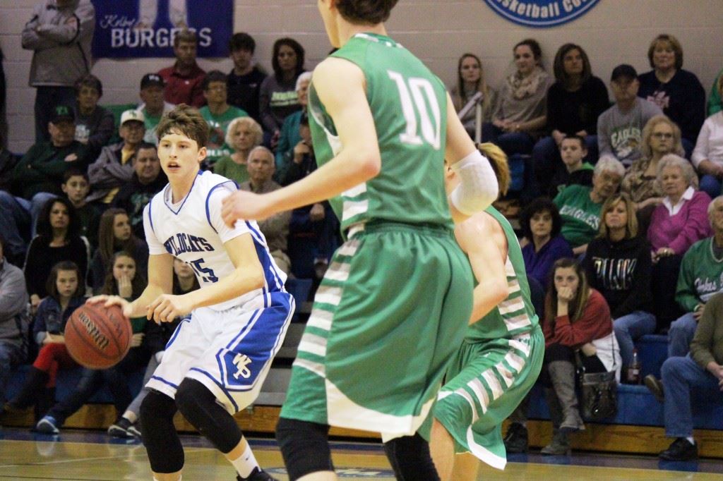 White Plains' Michael McGuirk (15) looks to move the ball around a couple Hokes Bluff defenders. McGuirk scored seven points in the fourth quarter Tuesday night. (Photo by Micaela Truett)