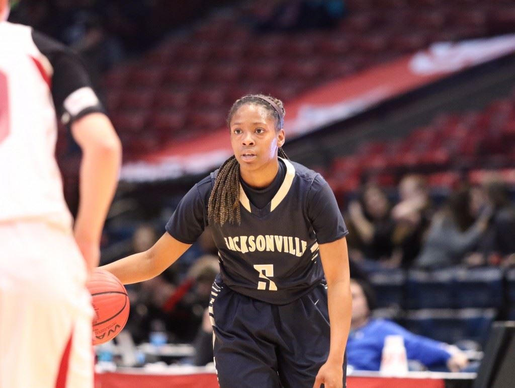 Jacksonville senior Angel Kidd is a picture of intensity as she contemplates her next move against UMS-Wright. On the bottom, senior Virginia Poe puts up a shot. On the cover, the Golden Eagles' bench erupts after their victory. (Photos by Kristen Stringer/Krisp Pics Photography)