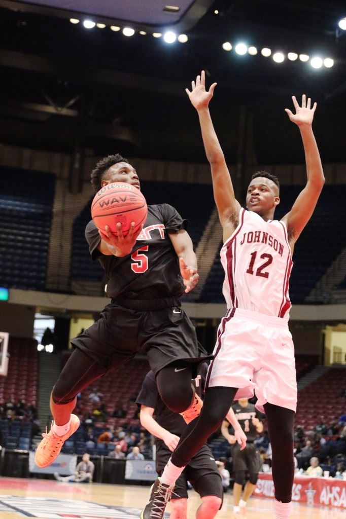 Sacred Heart's D.J. Heath (5) makes a move around A.L. Johnson's Gregory Baker. Heath was one of three Cardinals to post double-doubles in victory. (Photos by Kristen Stringer/Krisp Pics Photography)