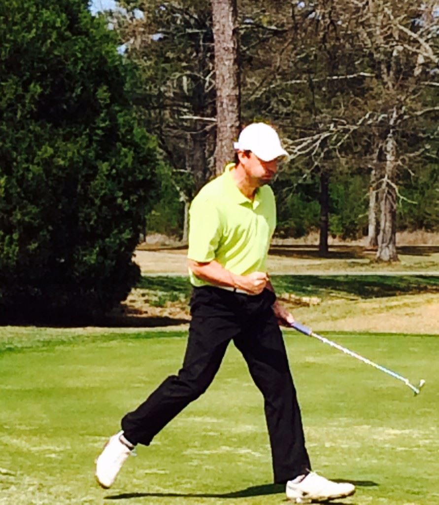 Jaylon Ellison pumps his fist after sinking a 30-foot eagle putt on 18 to give his team the tournament lead.