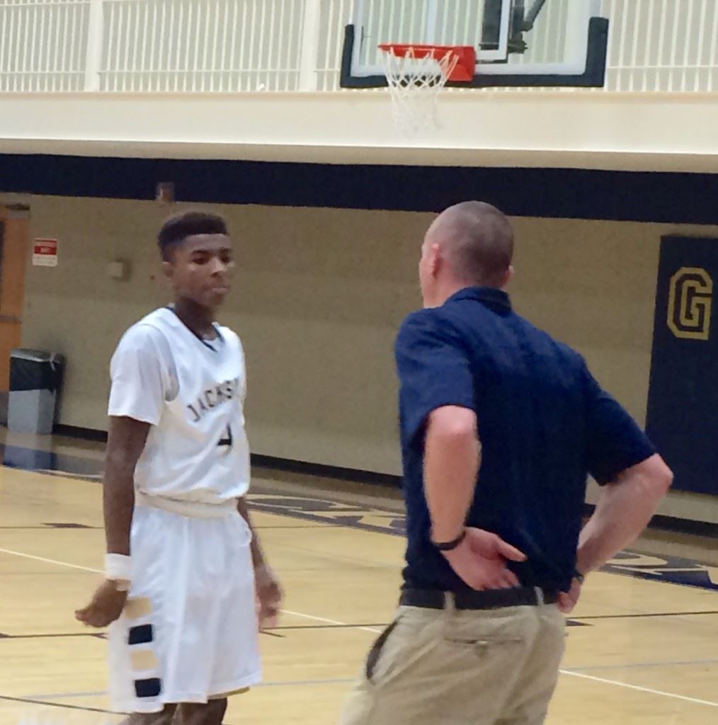 Jacksonville scorer Cam Horton gets some instruction from Golden Eagles coach Ryan Chambless.