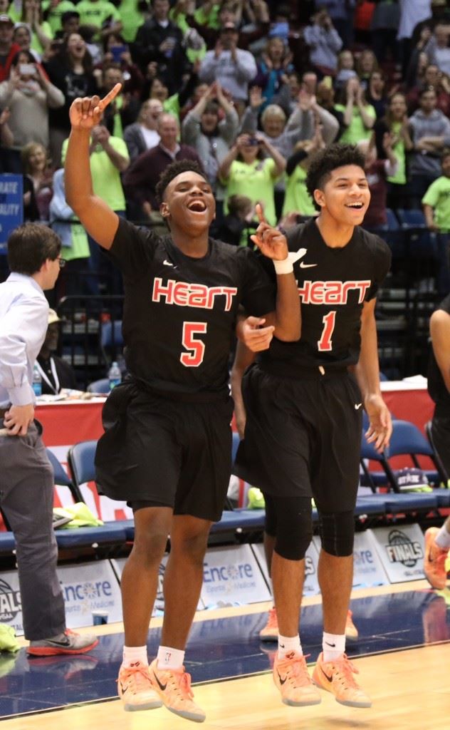 D.J. Heath (5) and Diante Wood erupt off the bench in the closing seconds of Sacred Heart's win in the state championship game. (Photo by Kristen Stringer/Krisp Pics Photography)