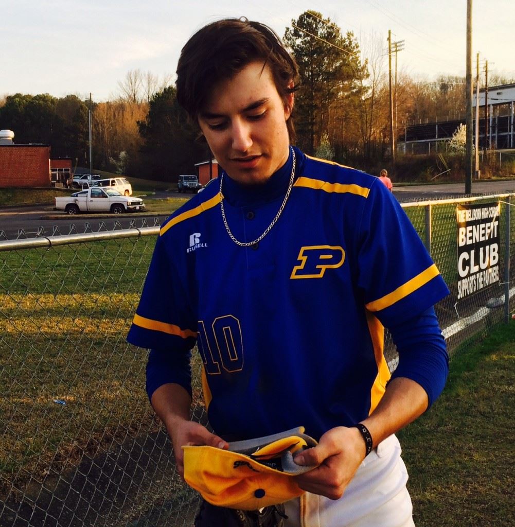 Piedmont pitcher Peyton Whitten checks to see just what is going on with his hat. Everytime he threw a pitch in the early innings Tuesday at Wellborn the cap kept flying off his head.