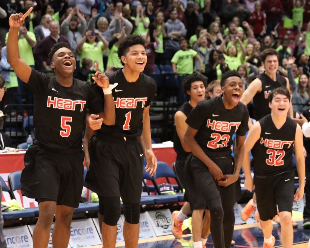 Sacred Heart players DJ Heath (5), Diante Wood (1), Kevion Nolan (23) and Tucker Norman (32) erupt off the bench as final seconds wind down in the Class 1A boys state championship game. (All photos by Kristen Stringer/Krisp Pics Photography).