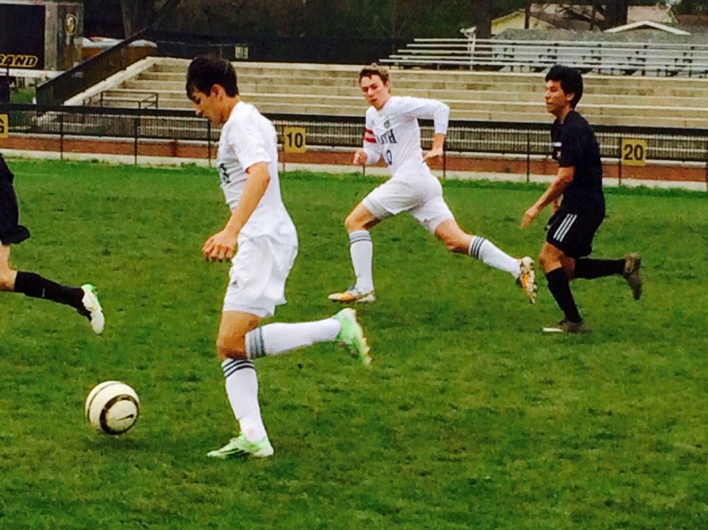 Faith's Tyler Johnson (L), the tournament's Offensive MVP, makes a run with teammate Josiah McDaniel (10). On the cover, first-goal scorer Byron Lin (13) and goalie Luis Jimenez, the Defensive MVP, celebrate with teammates after leading Oxford to the Yellow Jacket Invitational championship. 