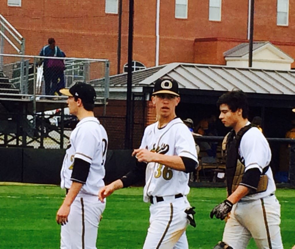 Sophomore catcher Derek Miller (R) comes off the field with Mason Wilkins (L) and Andy Hammond after Oxford blanked Piedmont 4-0.