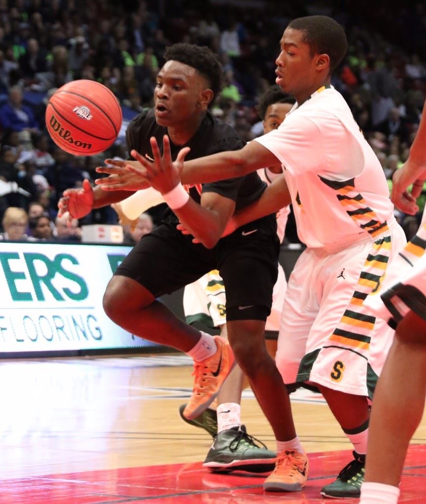 DJ Heath tries to corral a loose ball under the pressure of a Sunshine defender. 