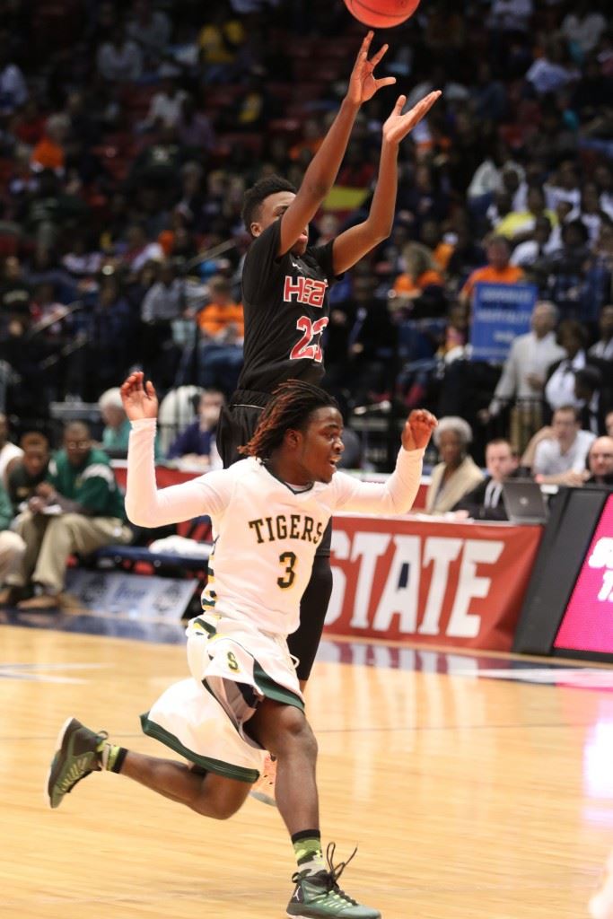 Kevion Nolan pulls up for a jumper as Sunshine's Lucky Travis (3) runs past.