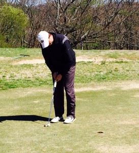 Andrew Brooks rechecks the line for his par putt on his 14th hole in the opening round of the King of the Hill at Anniston Municipal GC.