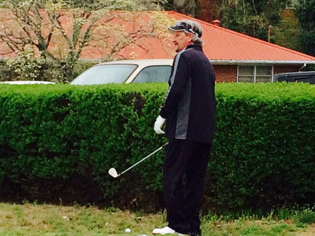 Jimbo Phillips contemplates his options from a tight spot near the 18th green Sunday.