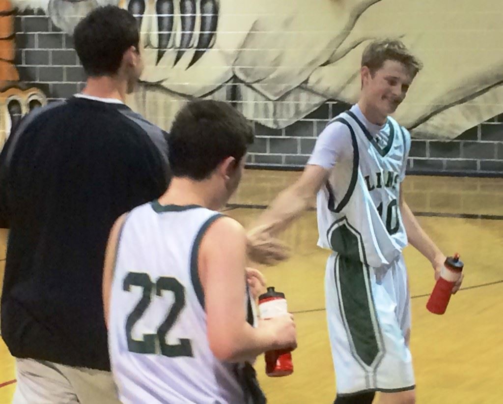 Caleb McCord (10) reaches back to high-five Faith coach Brad Yarbrough after going for 39 against Ohatchee in a holiday tournament at Heflin this season. Yarbrough was just named the Lions' head coach.