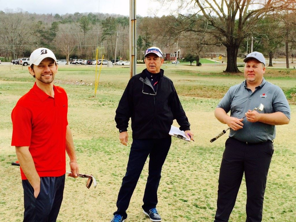 Eric Cannington (L) and Benji Turley (R) share a moment with Cane Creek pro Kenny Szuch before putting on the 18th green Saturday.