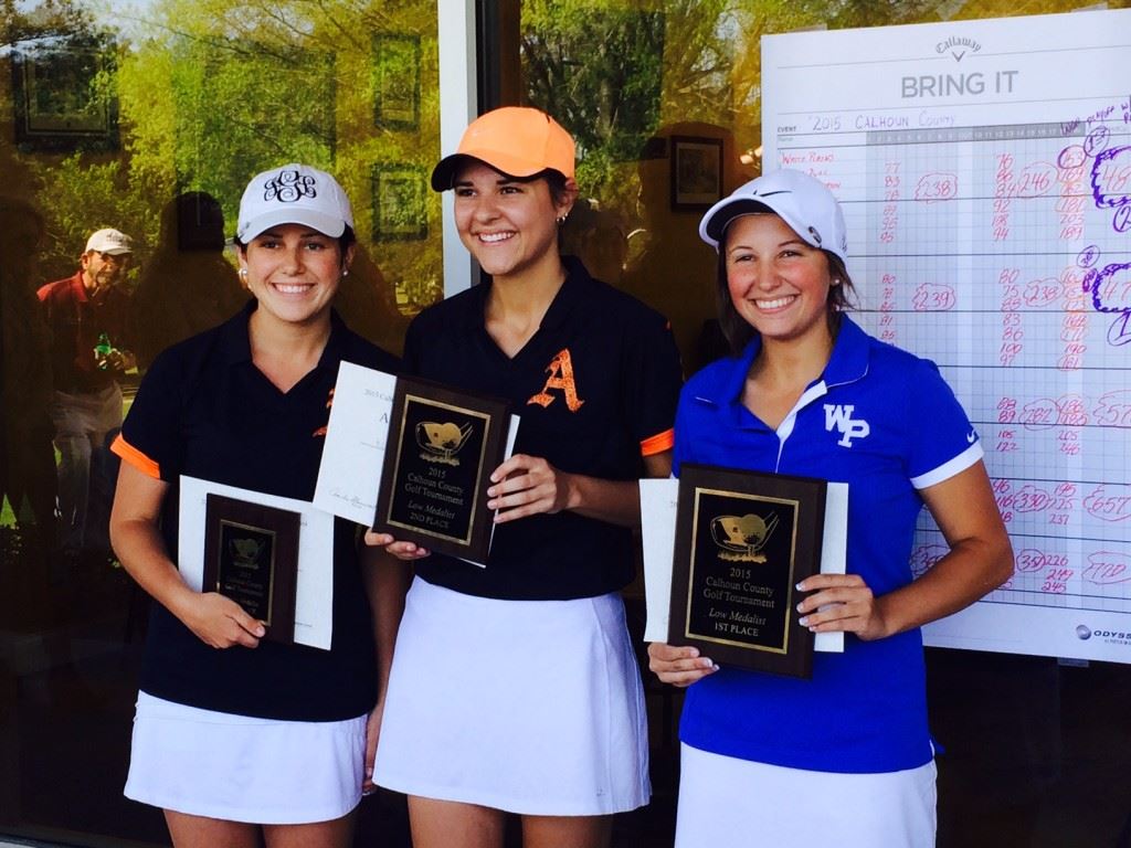 Playoff winner Layne Dyar (R) stands alongside runner-up Katie Roberts (C) and Jordan Gregoria at the awards ceremony. On the cover, Roberts and Gregoria celebrate Alexandria's team title with their teammates. 