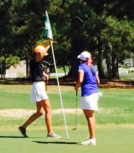 Alexandria's Katie Roberts (L) resets the pin before offering congratulations to White Plains' Layne Dyar at the end of their playoff Saturday. On the cover, White Plains boys Trevor Lane (L) and Nathan Gilbert (R) with East Alabama Sports Today content editor Al Muskewitz after a round at Pine Hill. (Photo by Eddy Reese)