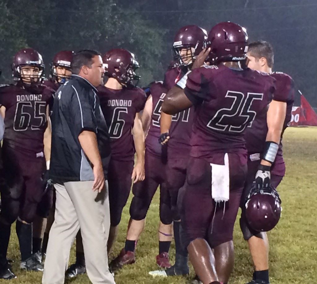 Andy McWilliams talks things over with the Donoho defense during a game last season. He was promoted to head coach Friday.