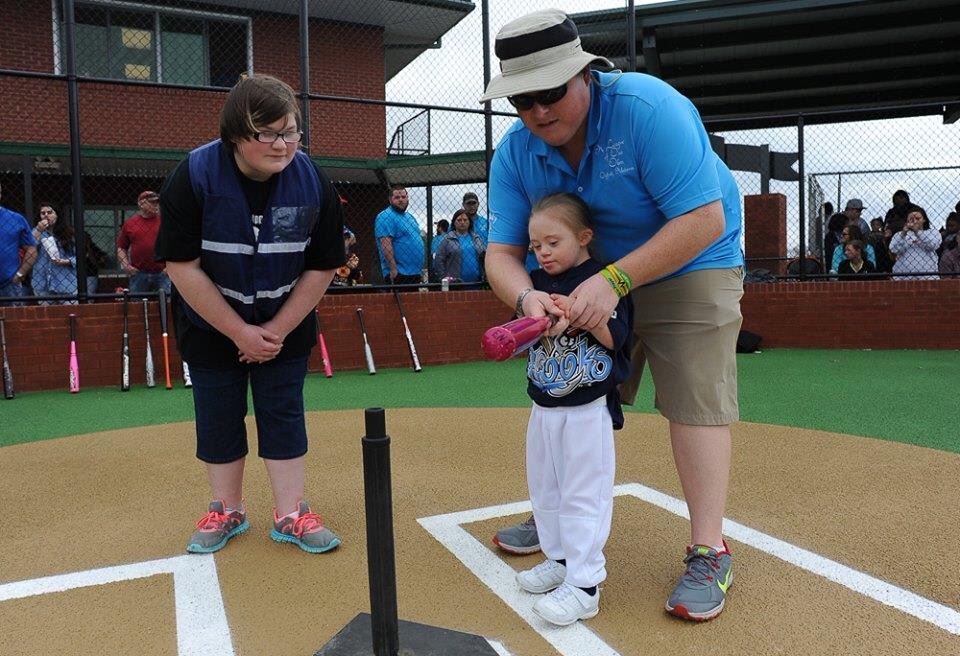 Batter up! A League of Our Own player gets an assistant from a "buddy" during the facility's opening weekend. (Photo by Joey D'Anna)