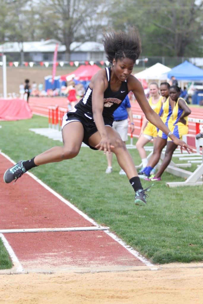 Carsheuna Curry played a key role in Anniston winning the County Girls Track title with wins in all three jumps. On the cover, Anniston's 4x400 relay team clinched the victory. (Photos by Kristen Stringer/Krisp Pics Photography).