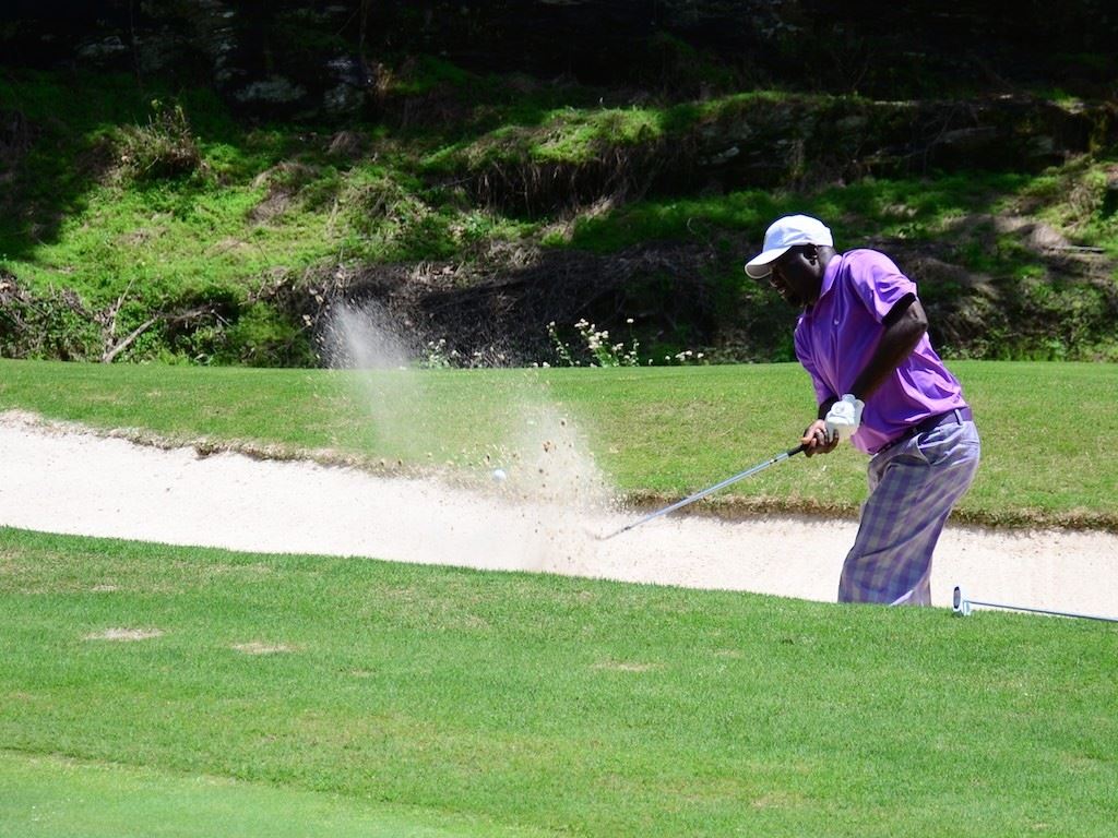 Maurice Dates of Talladega blasts out of the greenside bunker on 14 during play in the third flight Sunday.