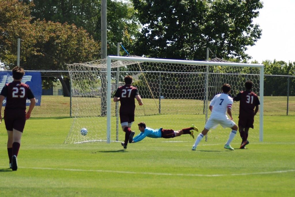 Tyler Johnson (7) and three Madison Academy defenders watch the Faith striker's second goal settle into the back of the net.