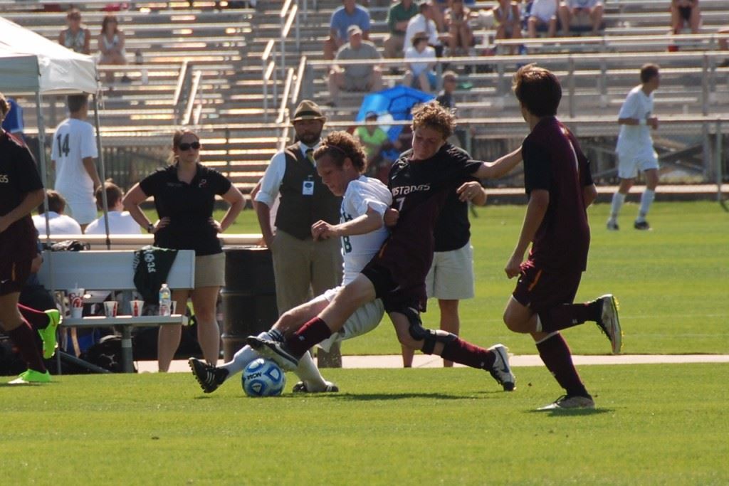 Andrew Gattrell makes a play on Madison Academy's Ryan Pollard (7) right in front of Faith coach Erik McDaniel.