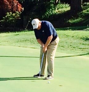 Cider Ridge director of golf Doug Wert sinks a putt on the 16th green Saturday.