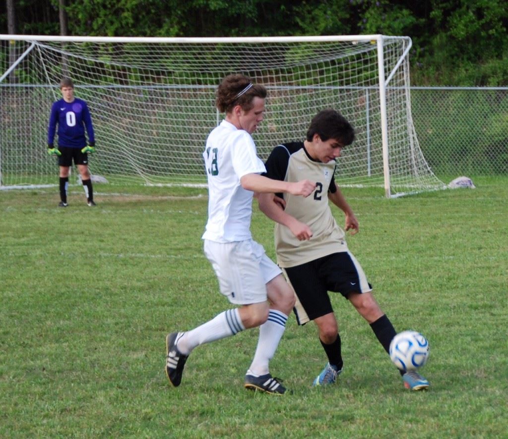 Faith senior midfielder Andrew Gattrell (18) marks an Altamont striker in an earlier playoff game. It's been said as Gattrell goes, so goes the Lions. (Photos by Tony Bedford).