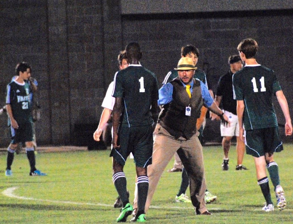 Faith coach Erik McDaniel meets Jordon Griswould (1) and Logan Williamson as they come off the field at the end of Friday's 1A-3A state championship match. (Photo by Tony Bedford)