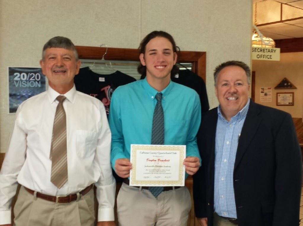 JCA quarterback Daylon Brackett is flanked by Calhoun County QB Club board members Gene Ellison (L) and Danny Shears after receiving one of the club's three scholarships Monday.