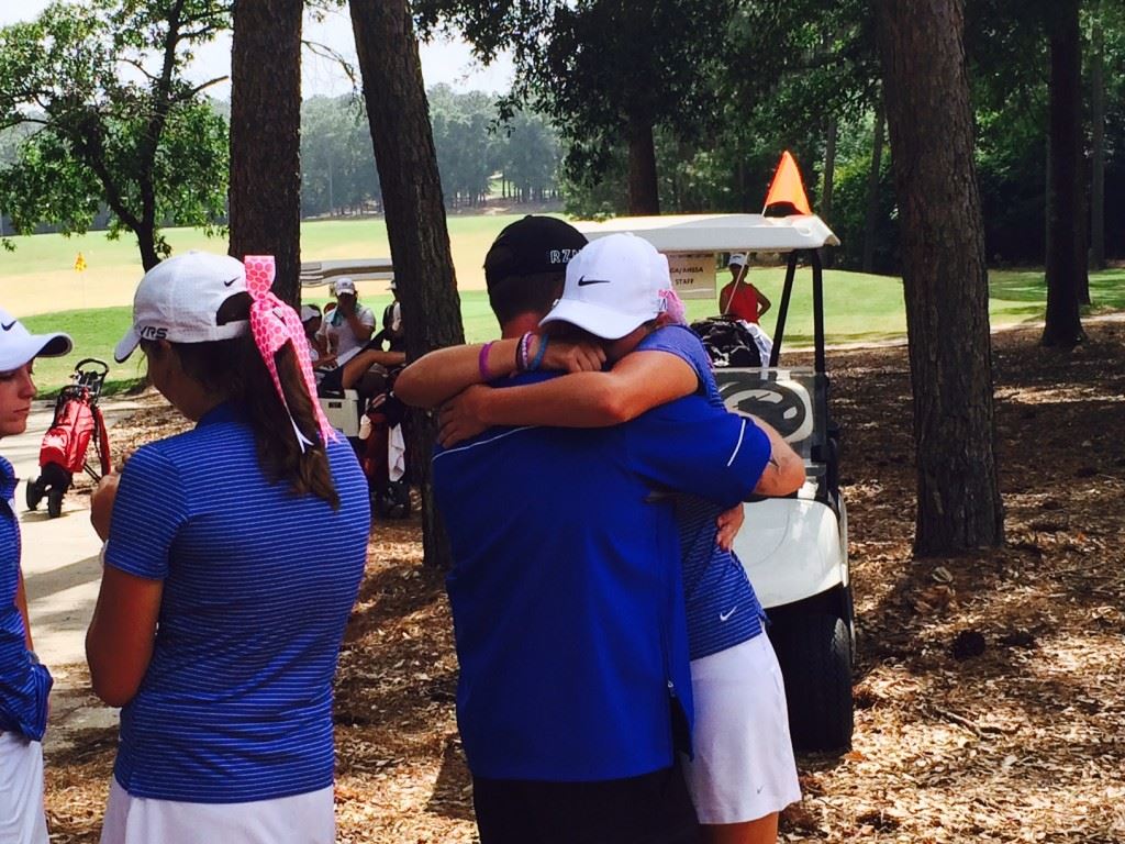 White Plains senior Raegan Thompson gives a big hug to assistant coach Brock Harrell after finishing her round in the state golf championship Tuesday. 