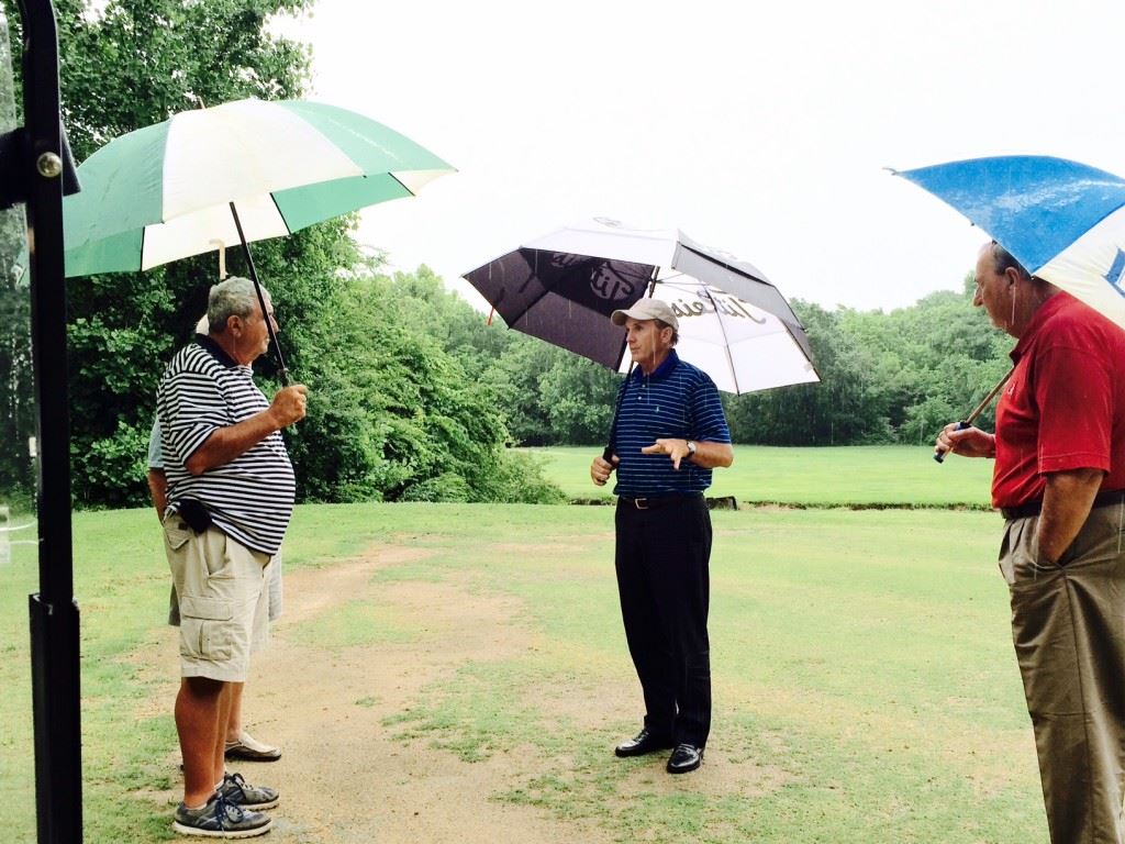 Former U.S. Open champion and Anniston resident Jerry Pate (C) gives Indian Oaks owner Ronnie Cofield (L) and pro shop manager Ron McClellan his opinion of the course's troubled No. 5 green.