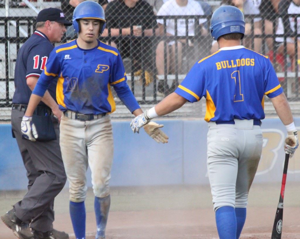 Piedmont's Peyton Whitten (L) is greeted by Taylor Hayes after scoring a run in the Bulldogs' 3A quarterfinal loss to Winfield Saturday. (Photo courtesy of Shannon Fagan/Cherokee County Herald)