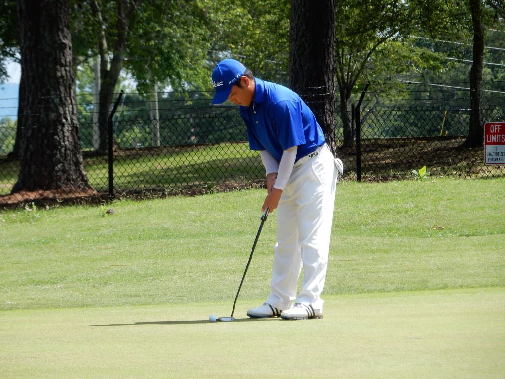 Andy Shim prepares to putt on the fifth green at Cane Creek Friday.