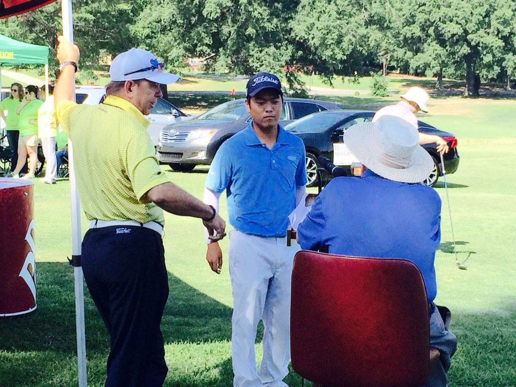 Andy Shim (C) visits with the starters prior to his round in the Fort McClellan Credit Union Pro-Invitational. Shim and second-round leader Kyle Sapp (cover) waged a back-and-forth battle early in the round.