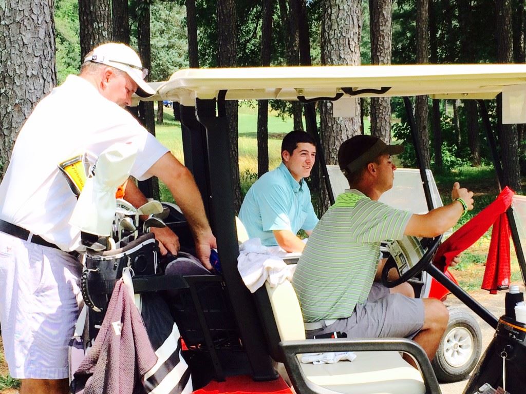 Dalton Chandler (C) shares a relaxing moment with playing competitors Gary Wigington (L) and Jeremy McGatha before starting the back nine in the Fort McClellan Credit Union Pro-Invitational Sunday at Cane Creek GC.