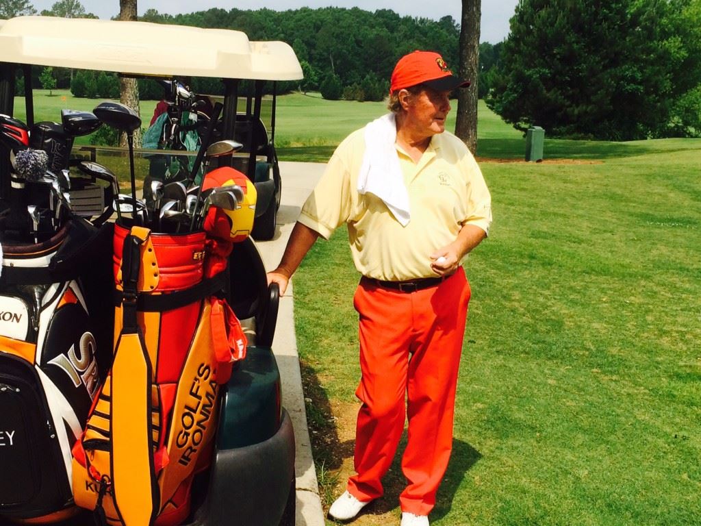 Colorful Bob Kurtz of Cullman looks back at the action taking place on the ninth green Tuesday. Kurtz is golf's ironman, holding several Guinness World Records for the number of holes and the speed at which they've been played. The marathon rounds he plays raise money for his Ministry to Children. 