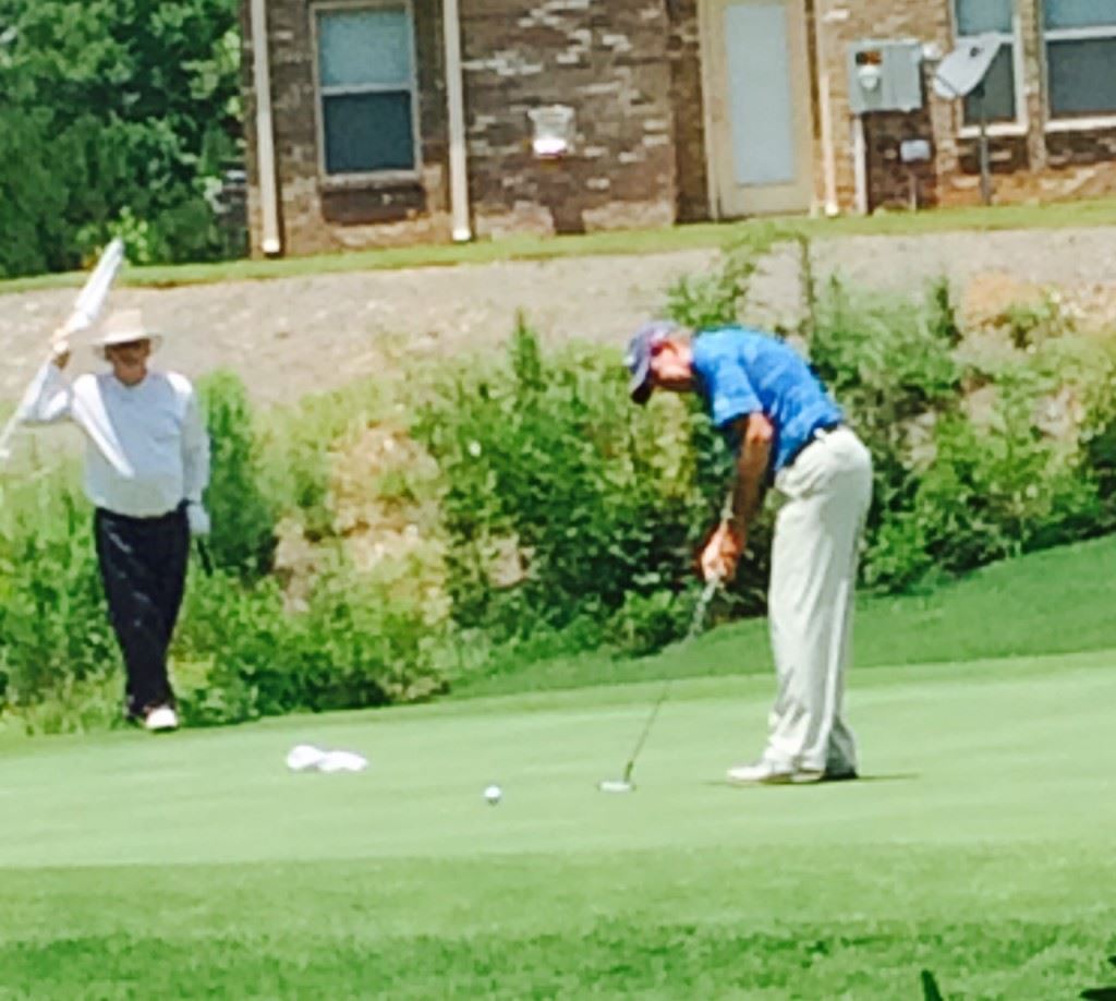 Danny Edwards drops a birdie putt on the 13th green that gave him the lead for good Thursday.