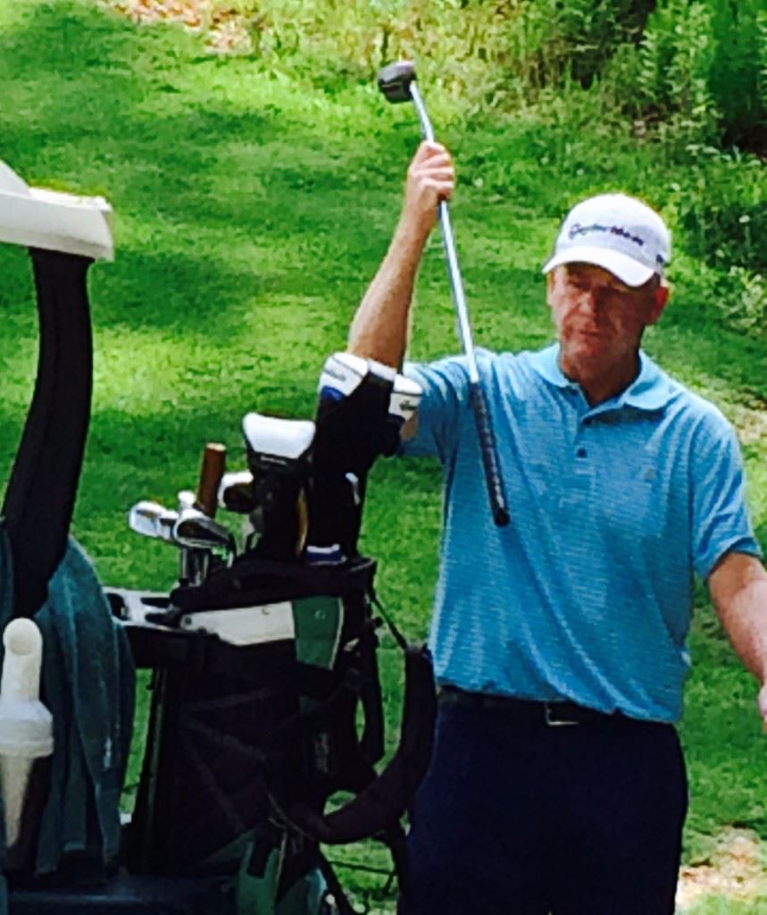 Roger Rowland returns his putter to the bag after dropping a birdie putt on No. 7. It was the second of five in a row he made in the middle of his round. 