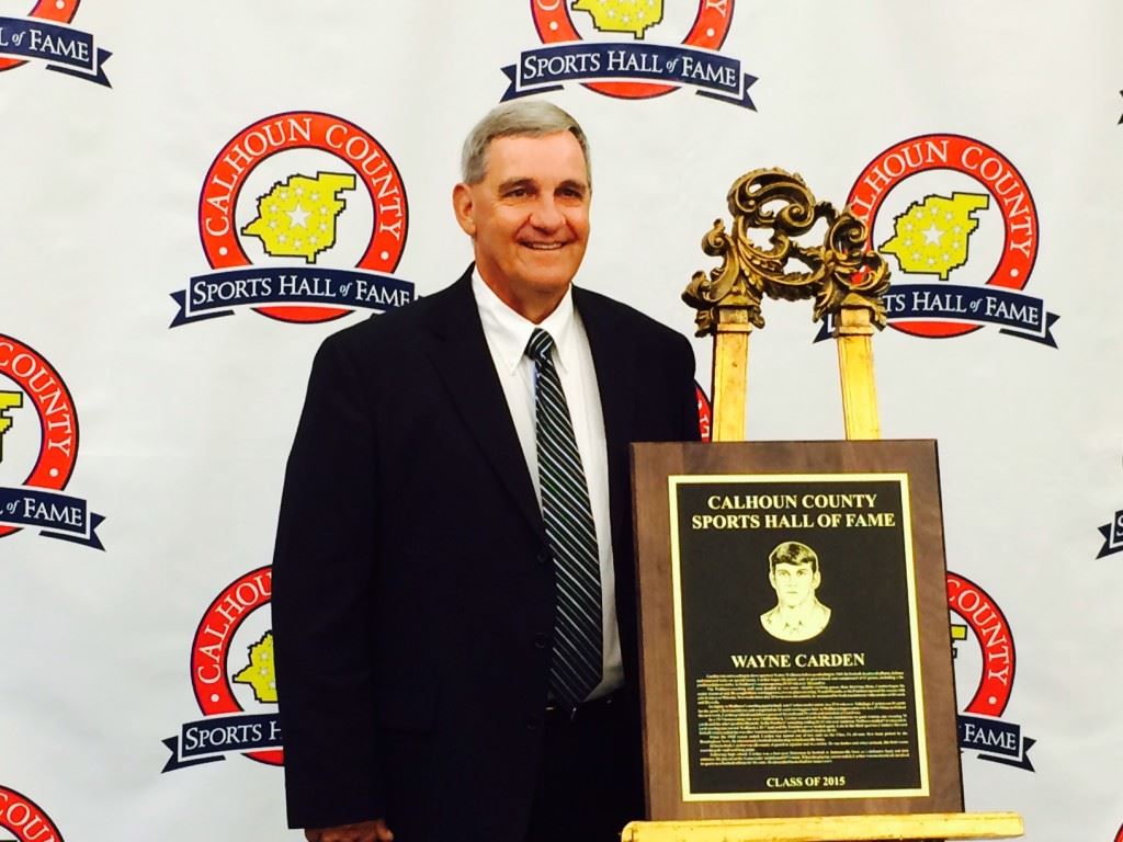 Wayne Carden stands with his plaque recognizing his induction into the Calhoun County Sports Hall of Fame. On the cover, inductees (from left) Howard Miller; Randy Cox, the son of Paul Cox; Carden; Henry O'Steen; Don Salls and Jerry Weems.