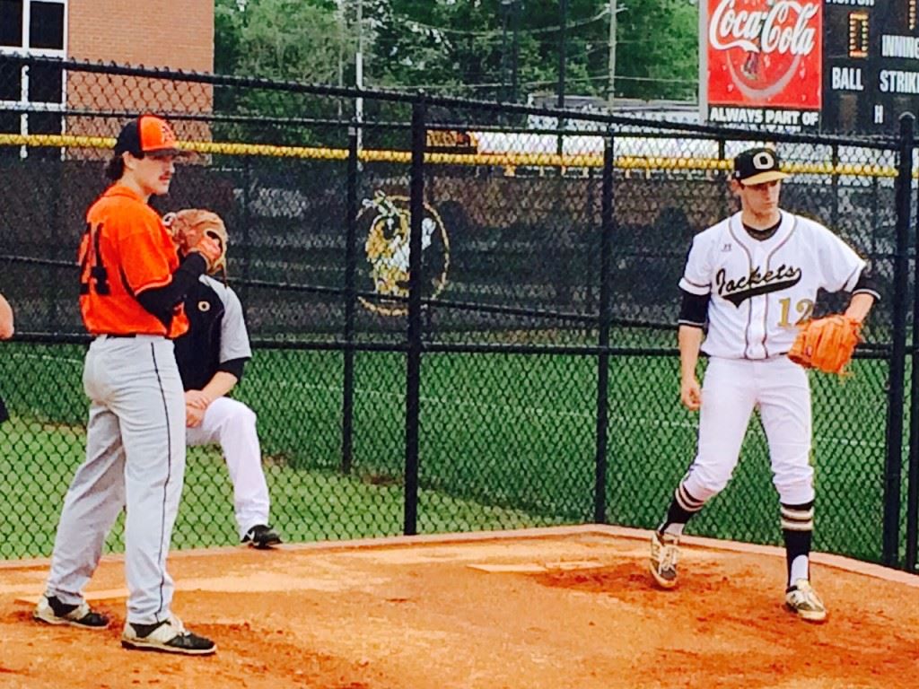 Oxford right-hander Mason Wilkins (R) warms up in the bullpen alongside Alexandria's Taylor Shaddix prior to the Yellow Jackets' Senior Day game in April.