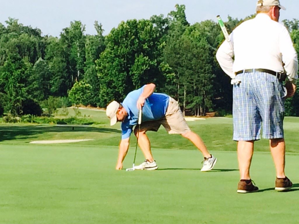 Jeff Bain pulls his birdie putt out of the cup on No. 1 that earned his team a halve in their match and Cider Ridge a draw with Anniston CC in their EA Sports Today Cup match Wednesday.