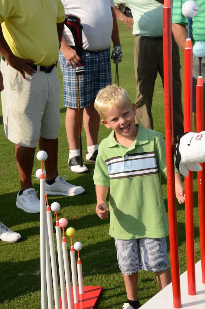 Five-year-old Conner Moore of Oxford is fascinated by the gadgets John Whitty uses during his trick-shot exhibitions. (Photo by B.J. Franklin)