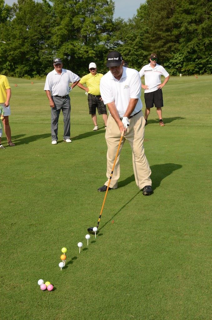 Myrtle Beach-area pro John Whitty hits shots with an extra-long driver during his trick-shot exhibition prior to the Oxford Senior Open Pro-Am Monday. (Photo by B.J. Franklin)